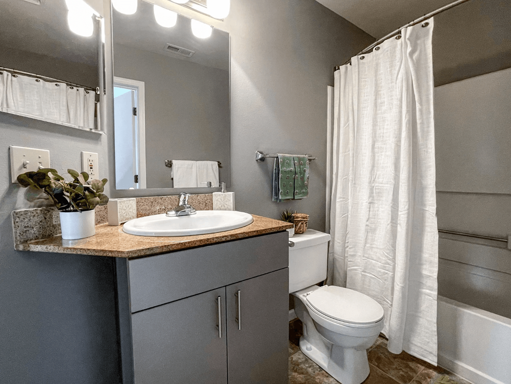 a bathroom with a sink toilet and a shower