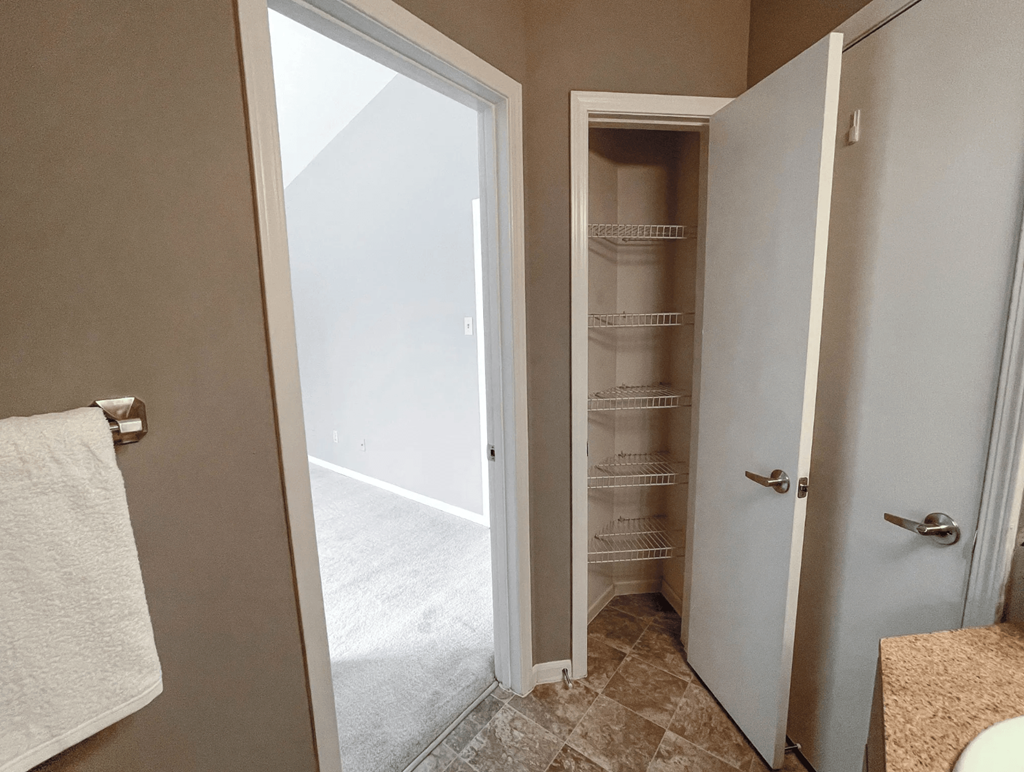 a small bathroom with a closet and a toilet and a sink