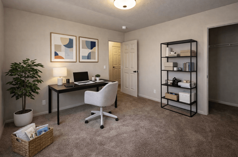 A room with a desk, chair, and shelves.