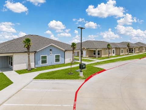 A row of houses with a red line painted on the sidewalk.