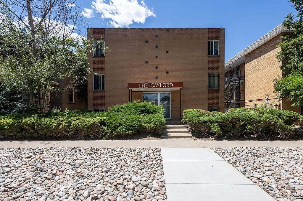 The entrance to a building named The Gaylord with a stone pathway leading to it.