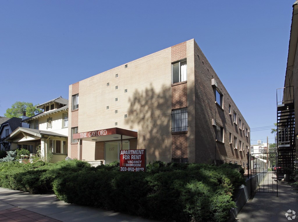 Apartment building with a sign that says "The CW Ord" and "Apartment for Rent".