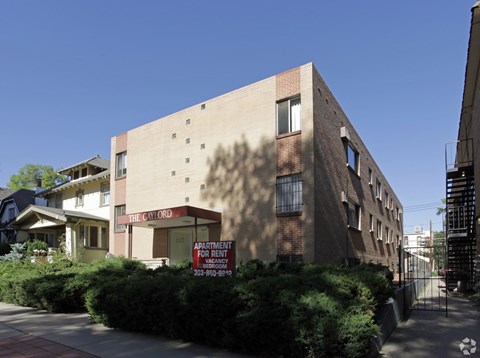 Apartment building with a sign that says "The CW Ord" and "Apartment for Rent".