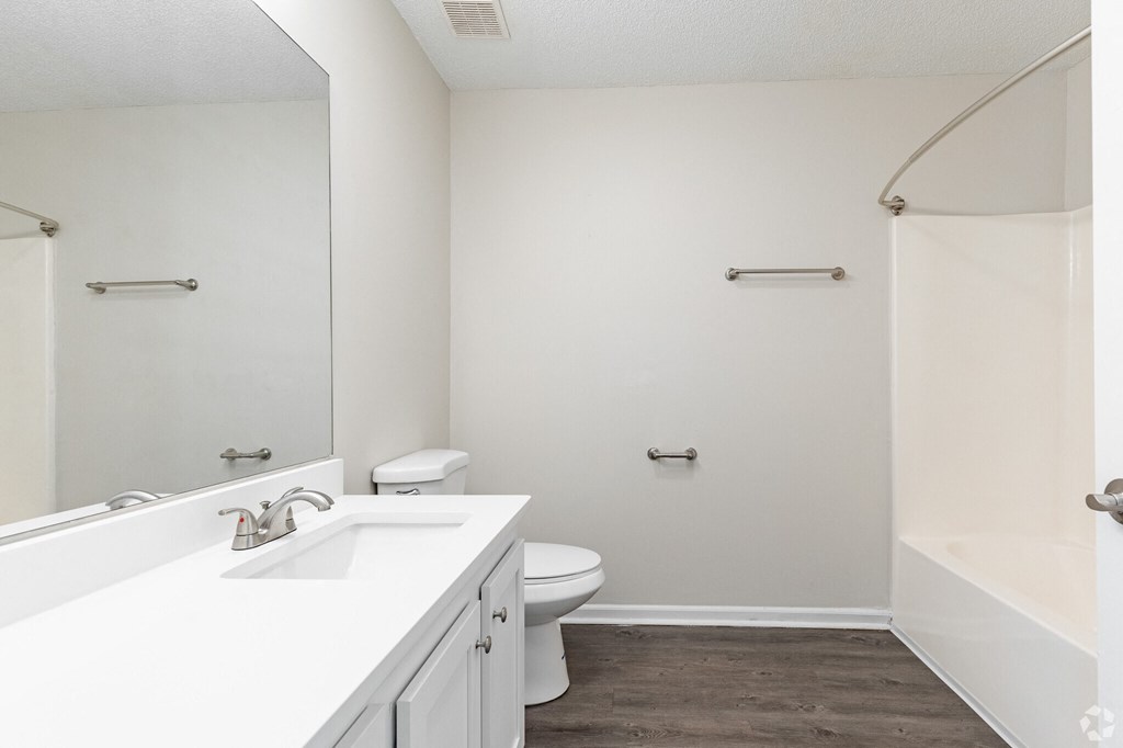 A white bathroom with a toilet and sink.