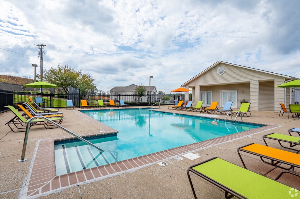 A pool with a yellow and green sun lounger.