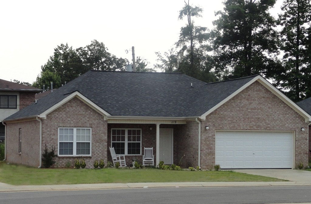 a house with a lawn and a white garage door