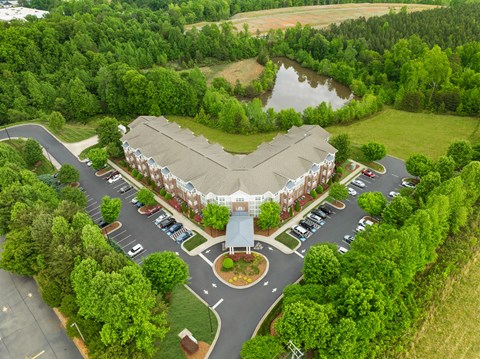 A large building with a parking lot in front of it.