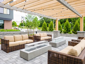 Pergola patio with couches, gas fireplaces, and overhead lighting - Photo Gallery 5