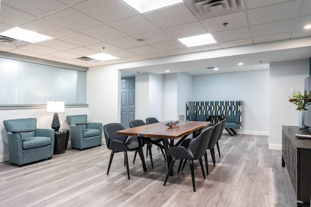 a meeting room with a table and chairs