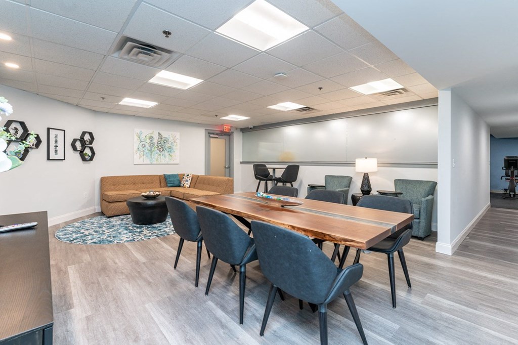 a conference room with a wooden table and chairs