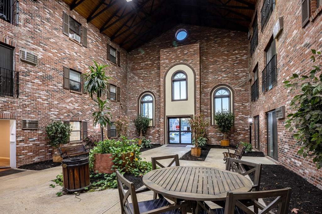 Kent apartment courtyard interior with lunch table.