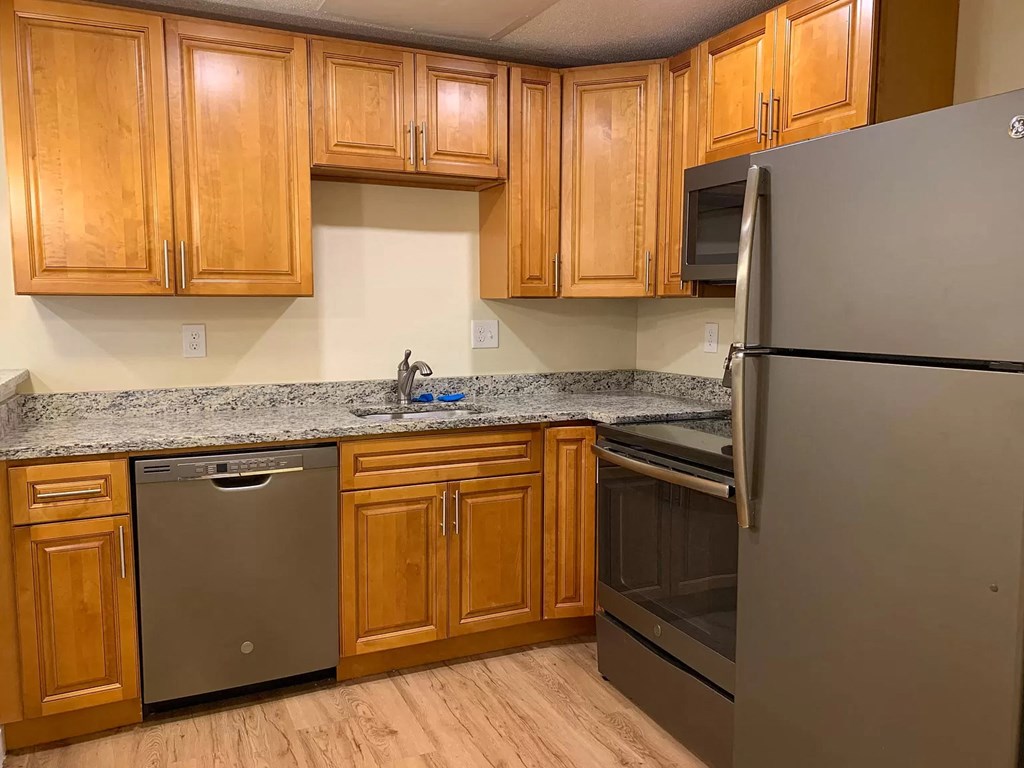 Essex Stoughton kitchen with granite countertops stainless appliances dishwasher range oven microwave