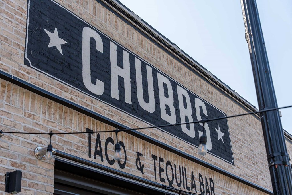 A brick building with a sign that says Chubbs Taco & Tequila Bar.
