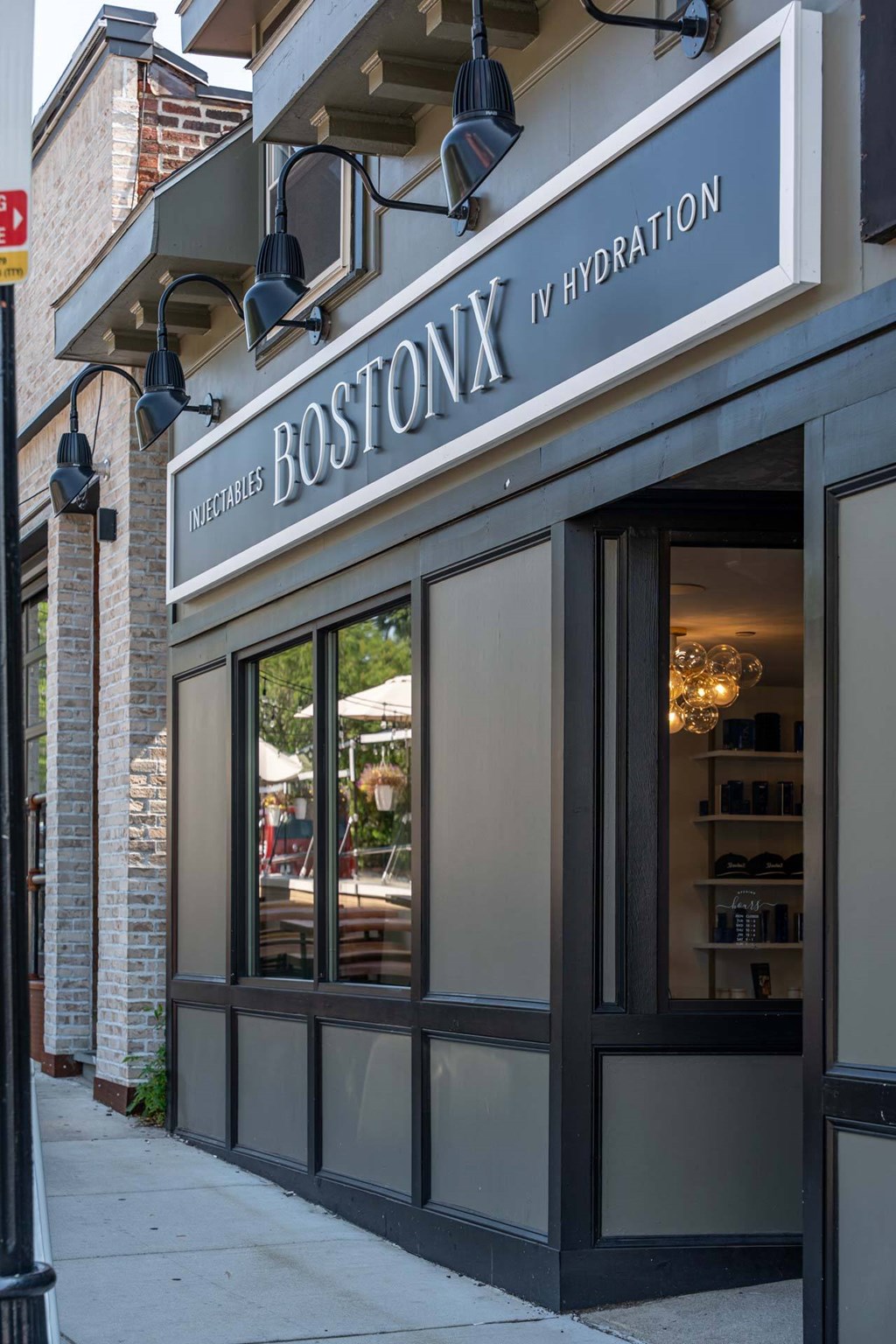 The Boston Hydration storefront is shown with a clear glass door and a sign above it.