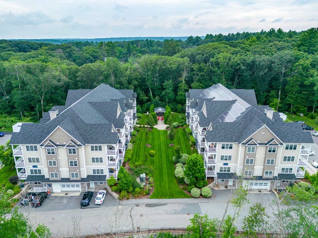 Aerial view of Ashland Woods, grilling station and apartment buildings with lush forest in background