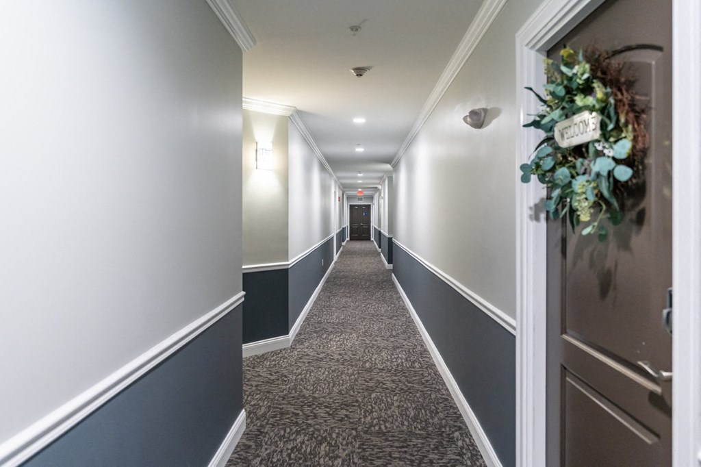 a long hallway with a bouquet of flowers on the door
