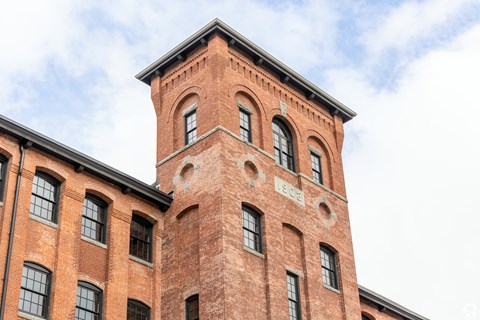 A red brick building with a tower and windows.