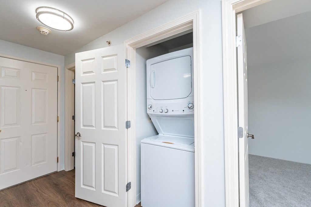an empty laundry room with a washer and dryer