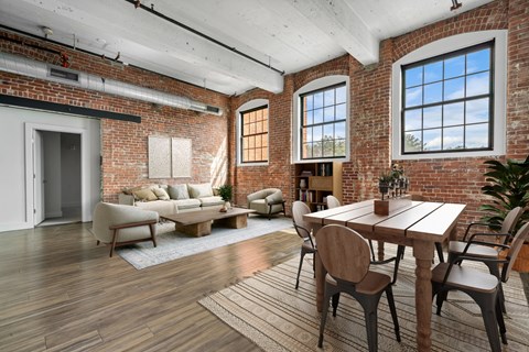 A room with a brick wall and a wooden floor.