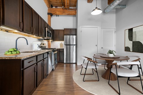 A kitchen with brown cabinets and a white fridge.