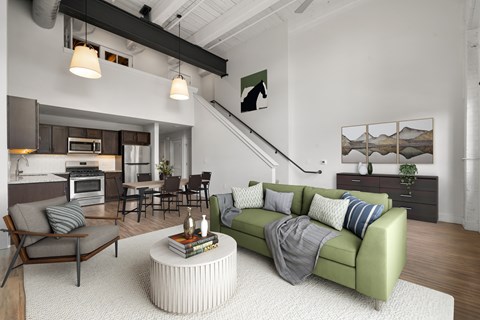 A living room with a green couch and a coffee table.