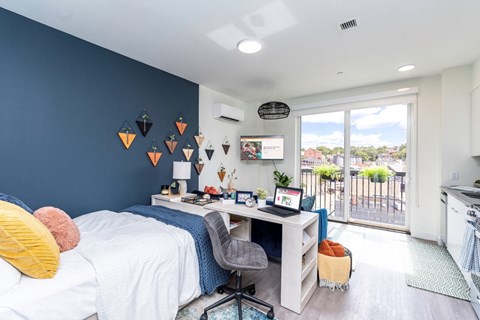a bedroom with a bed and a desk with a computer at Union 346, Massachusetts