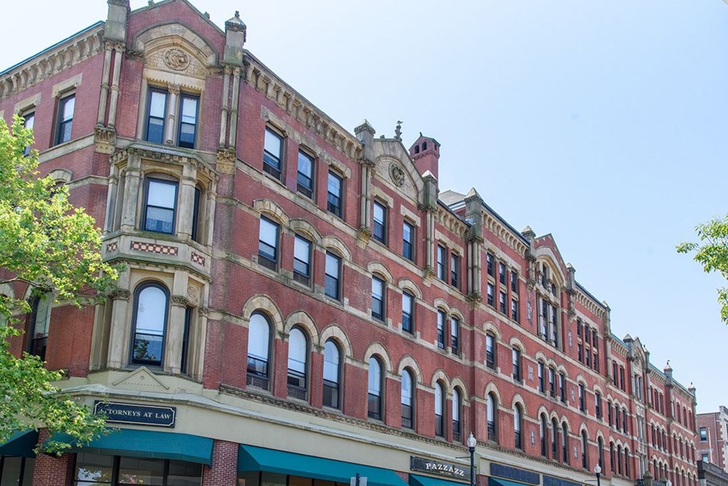 A red building with a green awning on the bottom left.