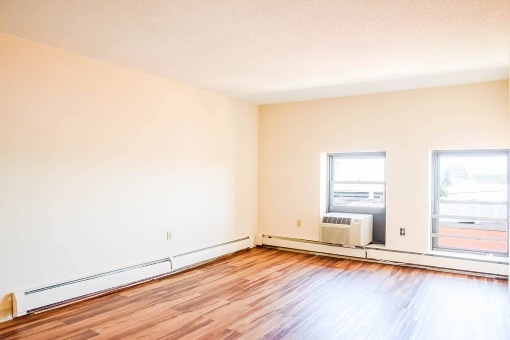 A room with a window and a heater.