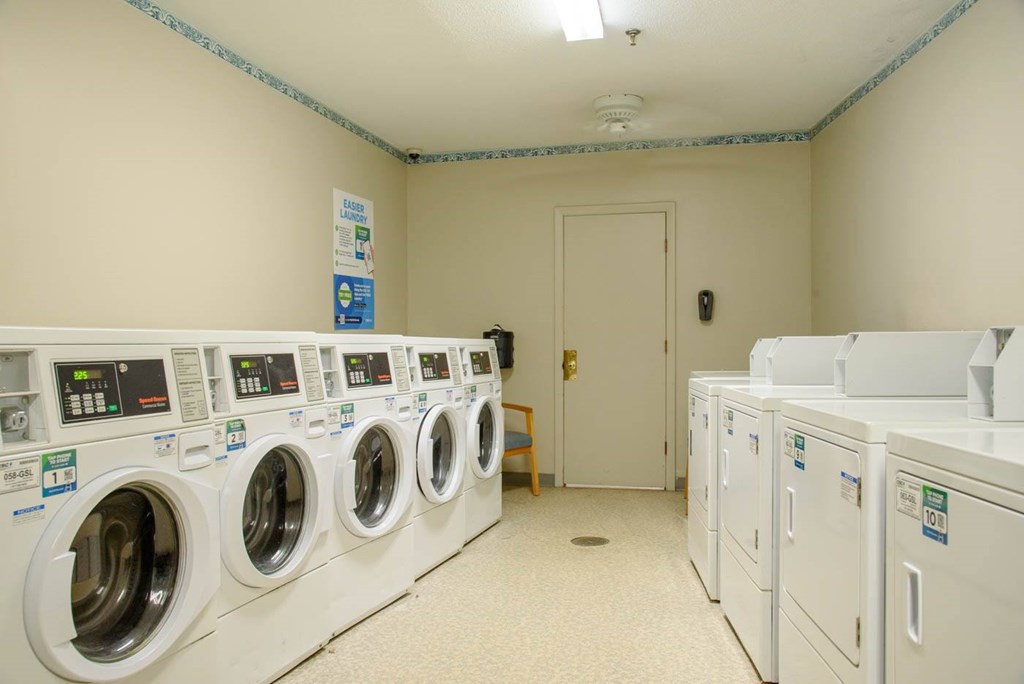 A row of washing machines in a laundromat.
