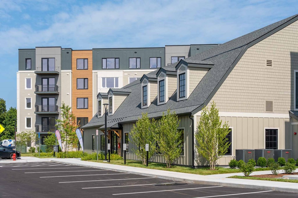 Exterior of The Devon at Weiss Farm apartments in Stoneham, MA featuring modern facade and landscaped grounds.