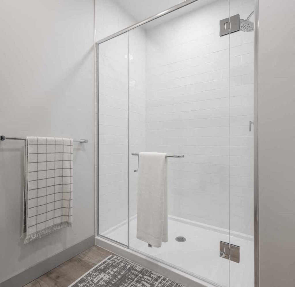 a bathroom with a shower and a towel rack