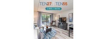 a spacious living room with a large sliding glass door leading to a patio