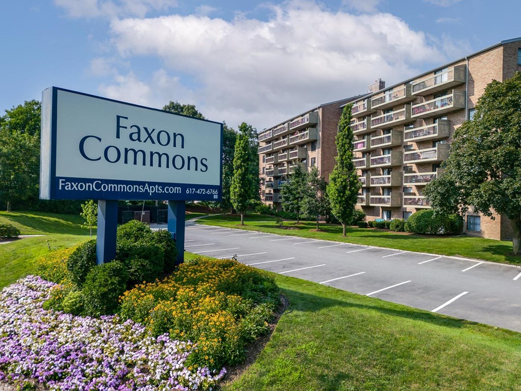 a sign that says faxon commons in front of a building