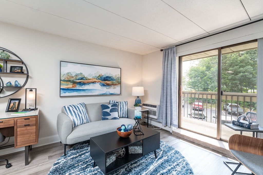 a living room with a couch coffee table and a sliding glass door