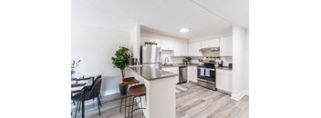 a kitchen and dining area in a 555 waverly unit