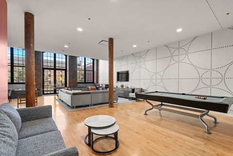 A room with a pool table and a couch.