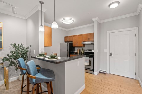 A kitchen with a bar area and a dining table.