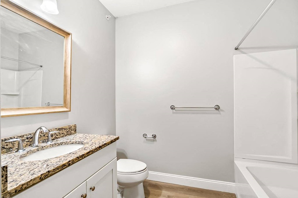 Ashland woods apartment bathroom with vinyl flooring, granite countertop
