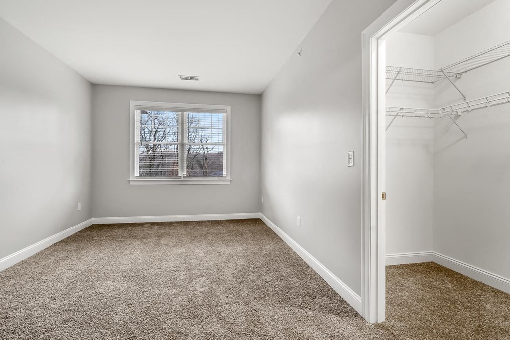 Ashland woods apartments with walk in closet and bedroom with plush carpeting