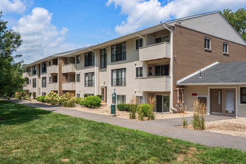 Apartment complex with a grassy area in front.