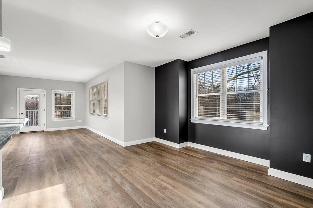 Ashland woods apartment large floor plan, accent wall, and large open windows.