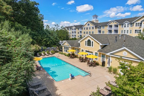 A large building with a pool in front of it.