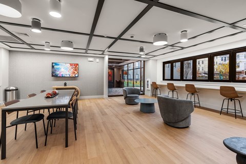 A modern dining room with a long table and chairs.