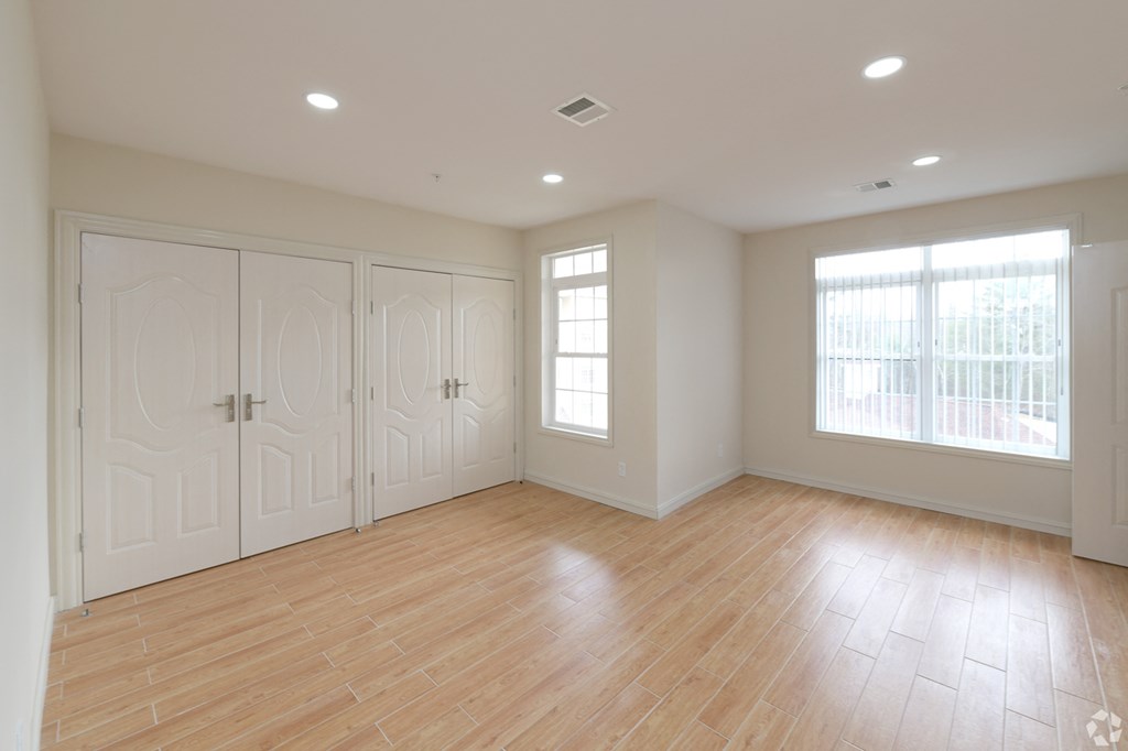 new apartment room with plenty of lighting and closet space