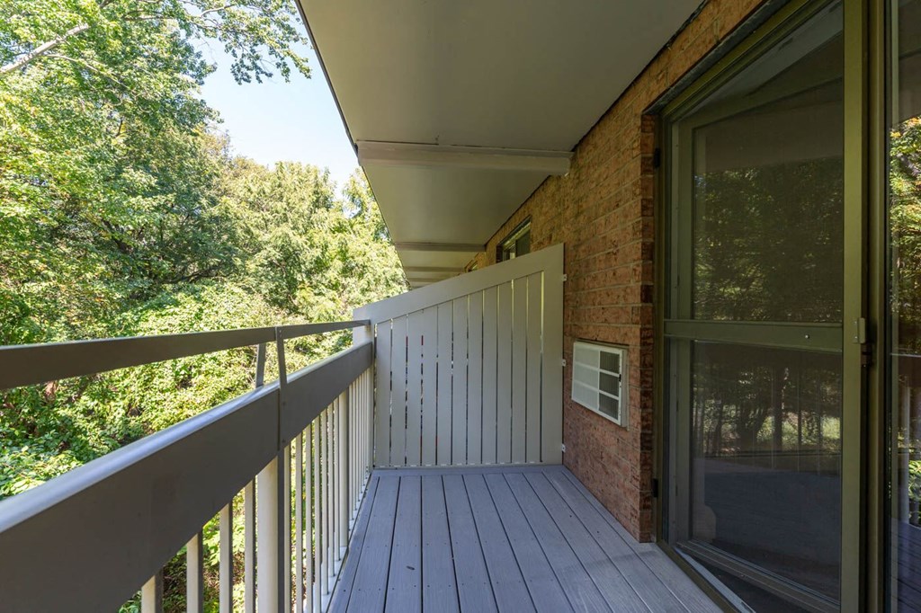 a balcony with a view of trees and a deck