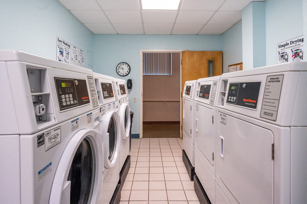 a washer and dryer laundry room with rows of washing machines