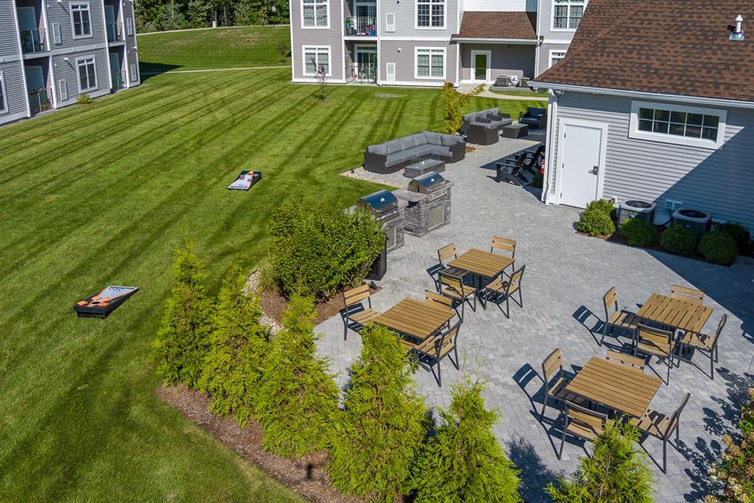 Outdoor patio, grills, fire pit, and cornhole