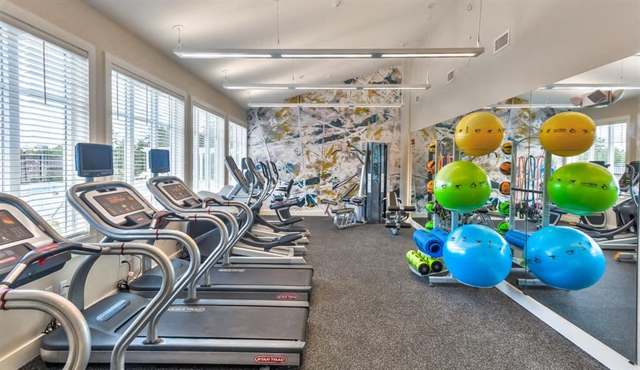 Redbrook community room fitness center with cardio equipment, free weights, and cable machines