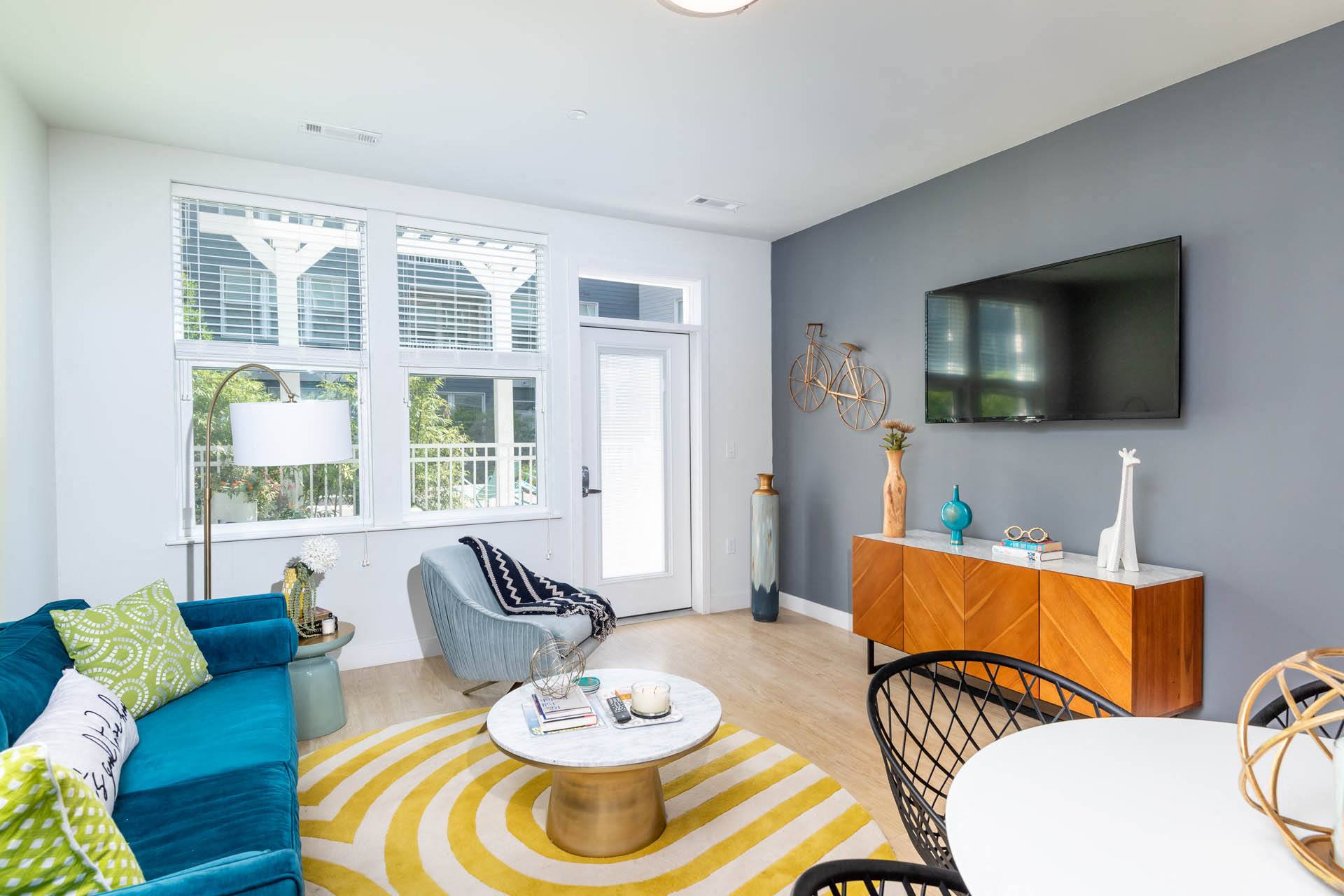 a living room with a blue couch and a tv