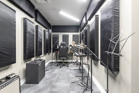 a recording studio with a variety of instruments and microphones